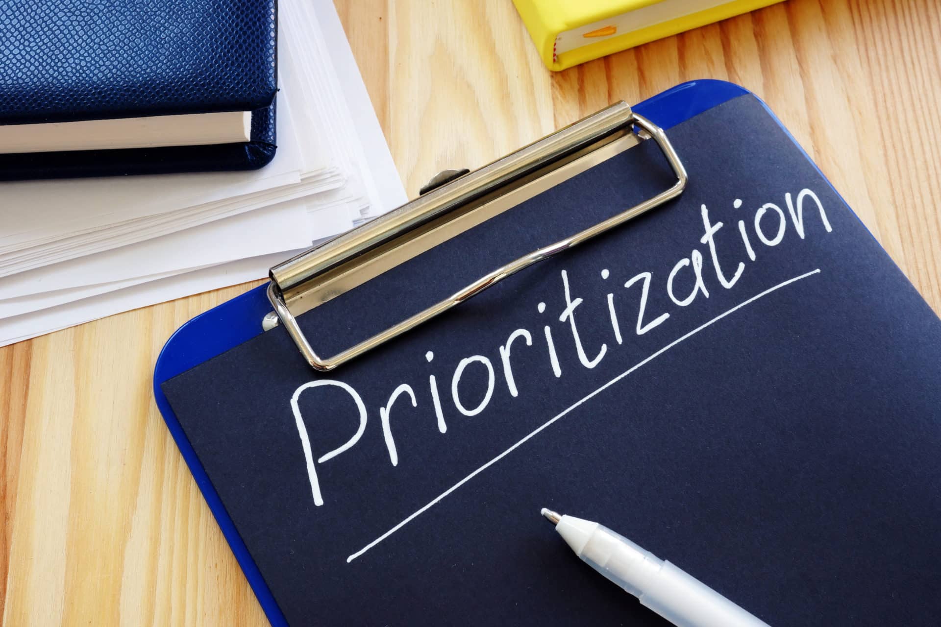 Prioritization handwritten sign on the black page. Prioritization
